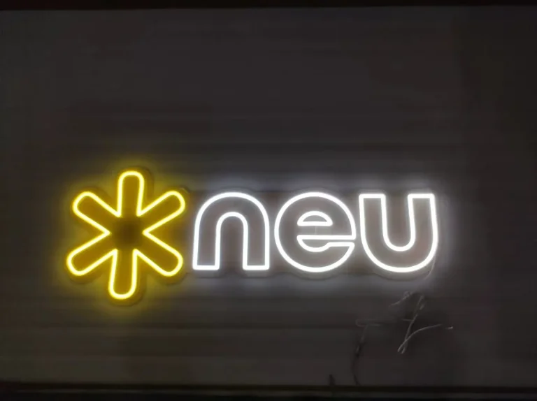 Yellow asterisk and white neu LED neon sign on dark wall ideal for modern business branding in Australia