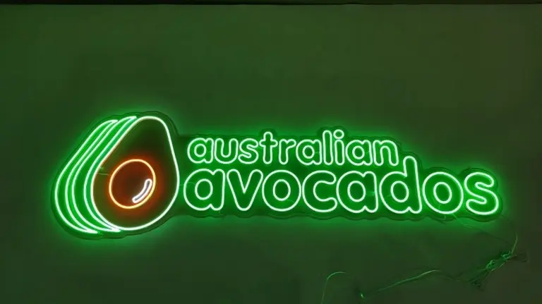 Green and orange LED neon sign featuring an avocado graphic and australian avocados text perfect for a business in Australia