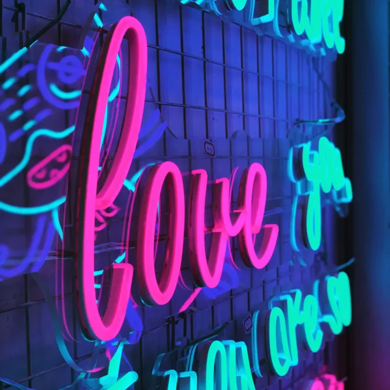 Pink Love and light blue you are LED neon signs on a grid wall perfect for events or home decor