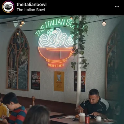 Custom LED neon sign featuring The Italian Bowl restaurant logo installed inside venue