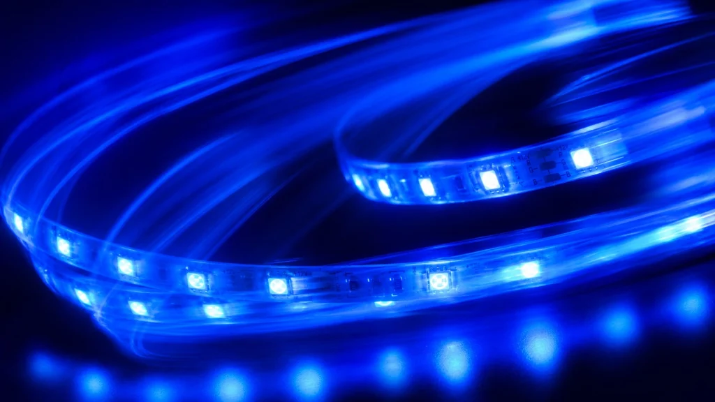 Abstract blue RGB LED neon strip lighting installed across a walkway ceiling with glowing motion effects.