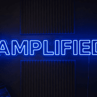 Amplified LED neon sign in bold clean sans-serif font in electric blue mounted on contour cut clear acrylic