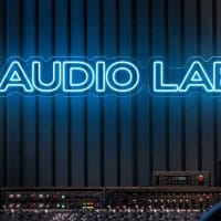 Audio Lab Neon Sign Audio Lab LED neon sign in ice blue in professional recording setup with acoustic wall panels