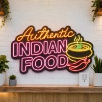 Authentic Indian Food LED neon sign on clear acrylic backing mounted on white brick wall