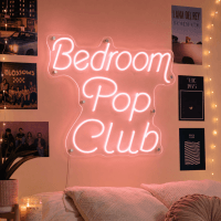 Bedroom Pop Club neon sign glowing in a music studio