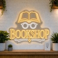 Bookshop LED neon sign with open book and reading glasses icons on clear acrylic backing