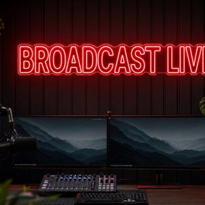 Broadcast Live LED neon sign in red in dark streaming setup with premium monitors