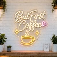 But First Coffee LED neon sign on clear acrylic backing mounted on white brick wall