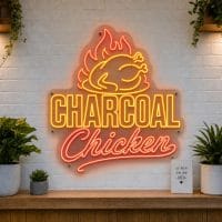 Charcoal Chicken LED neon sign with roast chicken and flame icons on clear acrylic backing mounted on white brick wall