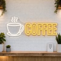 Coffee Cup and Word Coffee LED neon sign on clear acrylic backing mounted on white brick wall