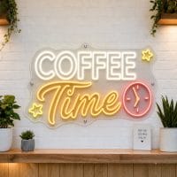 Coffee Time LED neon sign on clear acrylic backing mounted on white brick wall