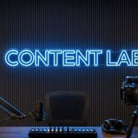 Content Lab Neon Sign Content Lab LED neon sign in ice blue in futuristic creator office with premium production setup