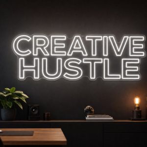 Creative Hustle LED neon sign in white in modern startup office with cinematic creator environment