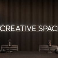 Creative Space LED neon sign in white in luxury co-working office with premium minimal styling