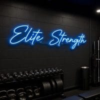 An 'Elite Strength' neon sign in ice blue, contour cut on clear acrylic, mounted on a dark moody training space wall with cinematic lighting and realistic LED glow.