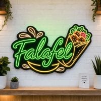Falafel LED neon sign on clear acrylic backing mounted on white brick wall