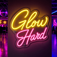 Glow Hard neon sign illuminated in a dark bar setting