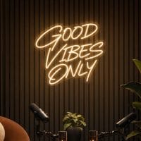 Good Vibes Only Neon Sign Good Vibes Only LED neon sign in warm white script in luxury creator lounge with soft ambient lighting