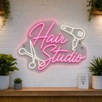Hair Studio LED neon sign with scissors and hair dryer icons on clear acrylic backing