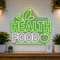 Health Food LED neon sign with leaf, apple, and heart icons on clear acrylic backing
