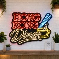 Hong Kong Diner LED neon sign on clear acrylic backing mounted on white brick wall