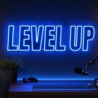 Level Up LED neon sign in electric blue in gaming creator setup with premium LED room