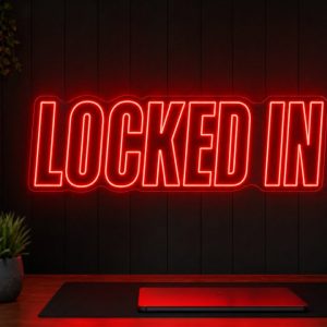 Locked In Neon Sign Locked In LED neon sign in red in dark focused creator setup with cinematic desk scene