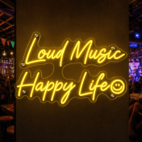 Loud Music Happy Life LED neon sign glowing in a music venue