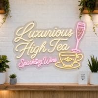 Luxurious High Tea LED neon sign on clear acrylic backing mounted on white brick wall