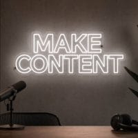Make Content Neon Sign Make Content LED neon sign in white in minimalist creator room with clean architecture