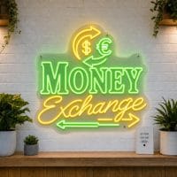 Money Exchange LED neon sign with arrows and currency symbols on clear acrylic backing mounted on white brick wall
