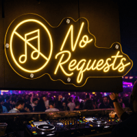 No Requests LED neon sign glowing in a bar