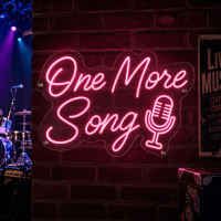 One More Song Neon Sign glowing in music venue