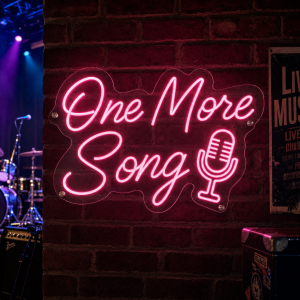 One More Song Neon Sign glowing in music venue