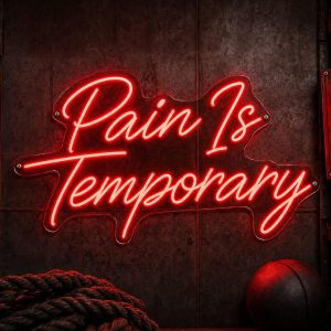 A red 'Pain Is Temporary' neon sign mounted on a dark, moody training space wall, with cinematic lighting and a realistic LED glow.