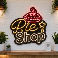 Pie Shop LED neon sign on clear acrylic backing mounted on white brick wall