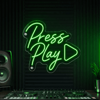 Press Play neon sign with play button icon lit up on wall