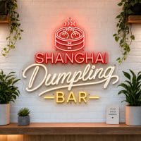 Shanghai Dumpling Bar LED neon sign on clear acrylic backing mounted on white brick wall