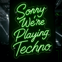 Sorry We're Playing Techno LED neon sign glowing in a music venue