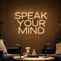 Speak Your Mind Neon Sign Speak Your Mind LED neon sign in warm white in luxury podcast lounge with modern interview environment