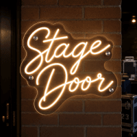 Stage door illuminated neon sign on wall