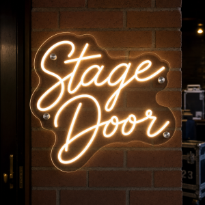 Stage door illuminated neon sign on wall
