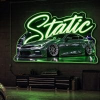 Static LED neon sign mounted on garage wall