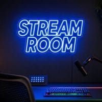 Stream Room LED neon sign in electric blue in modern gaming office with premium black desk