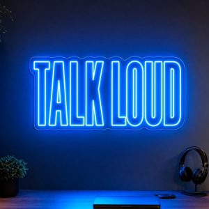 Talk Loud LED neon sign in electric blue in modern creator desk setup