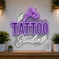 Tattoo Studio LED neon sign with tattoo machine and flash art icons on clear acrylic backing