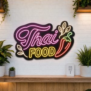 Thai Food LED neon sign on clear acrylic backing mounted on white brick wall