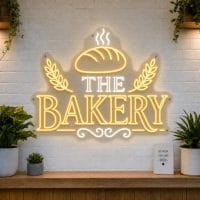 The Bakery LED neon sign with fresh loaf of bread and wheat sheaf icons on clear acrylic backing