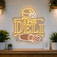 The Deli LED neon sign with charcuterie board and cheese icons on clear acrylic backing