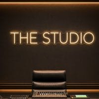 The Studio Neon Sign The Studio LED neon sign in warm white in minimalist luxury recording room with cinematic lighting